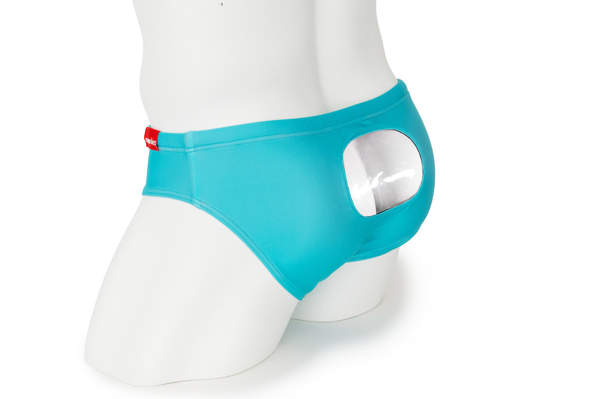 A mannequin wearing turquoise underwear with a circular open window on the back.